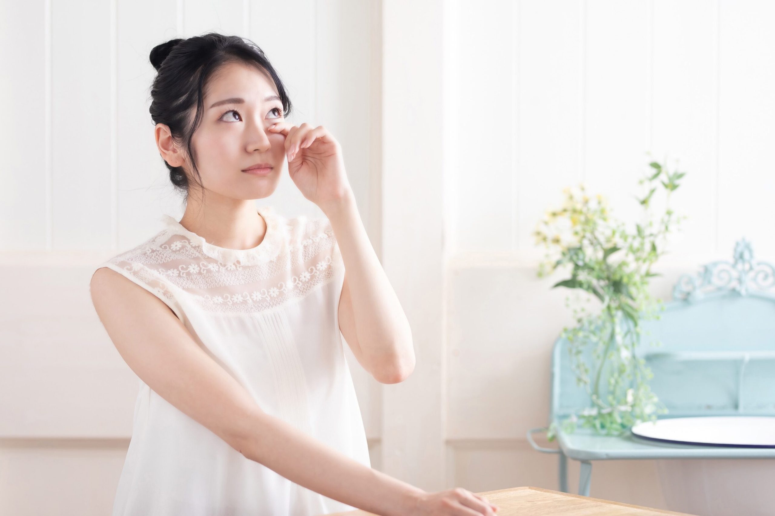 Woman touching her eyes in discomfort