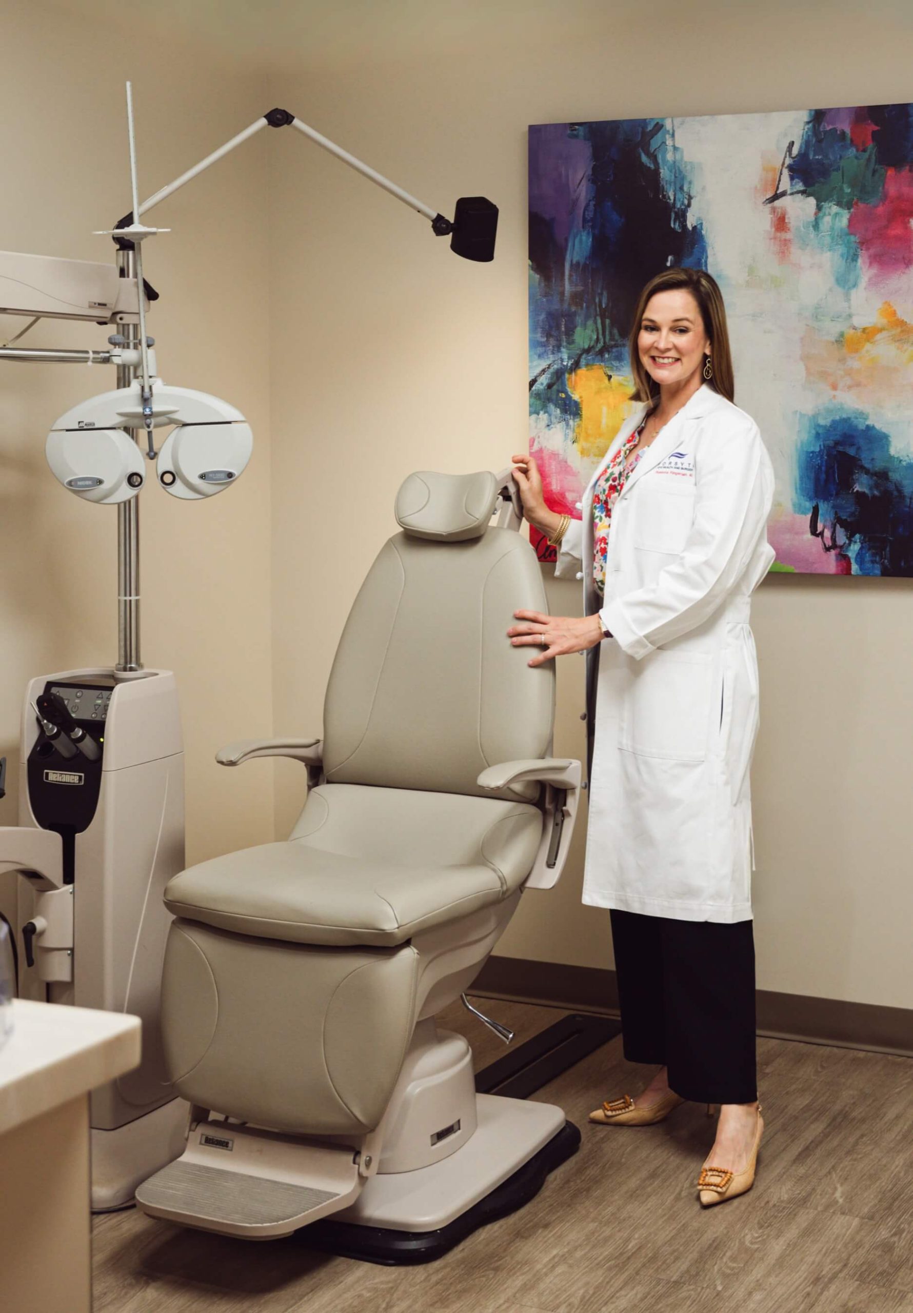 Dr. Ringeman beside the exam chair in a Forsyth Eye Health and Surgery exam room