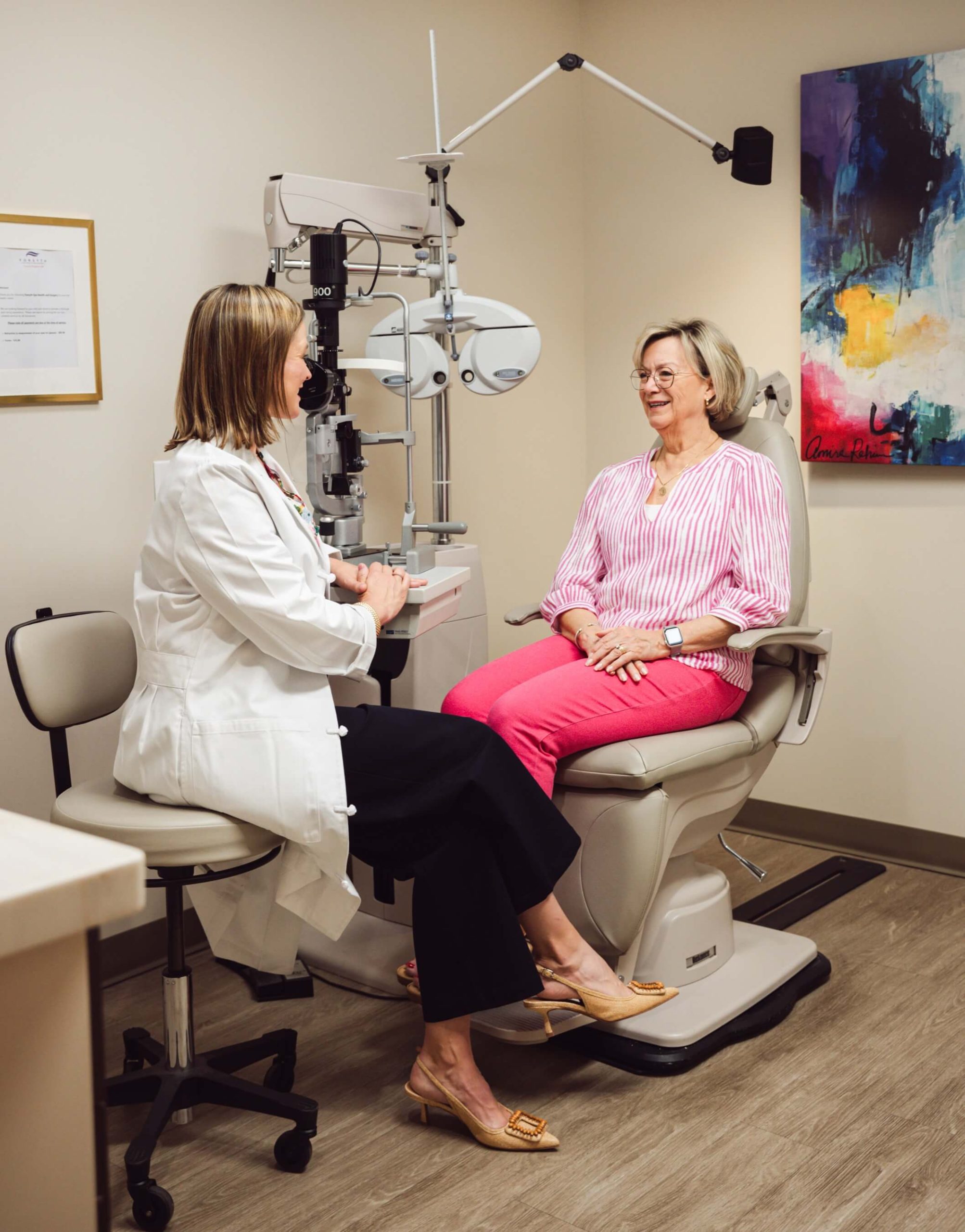 Forsyth Eye Health doctor reviewing exam findings with a seated patient