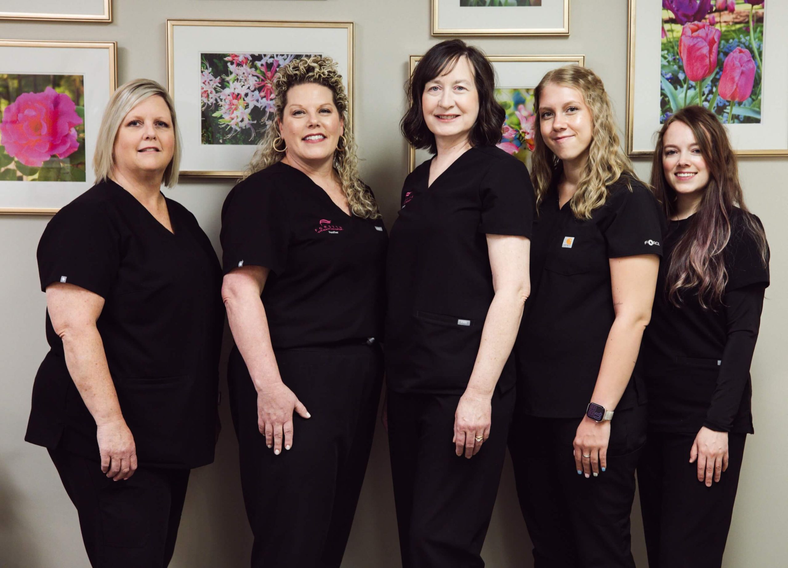 Five Forsyth Eye Health and Surgery staff members in scrubs