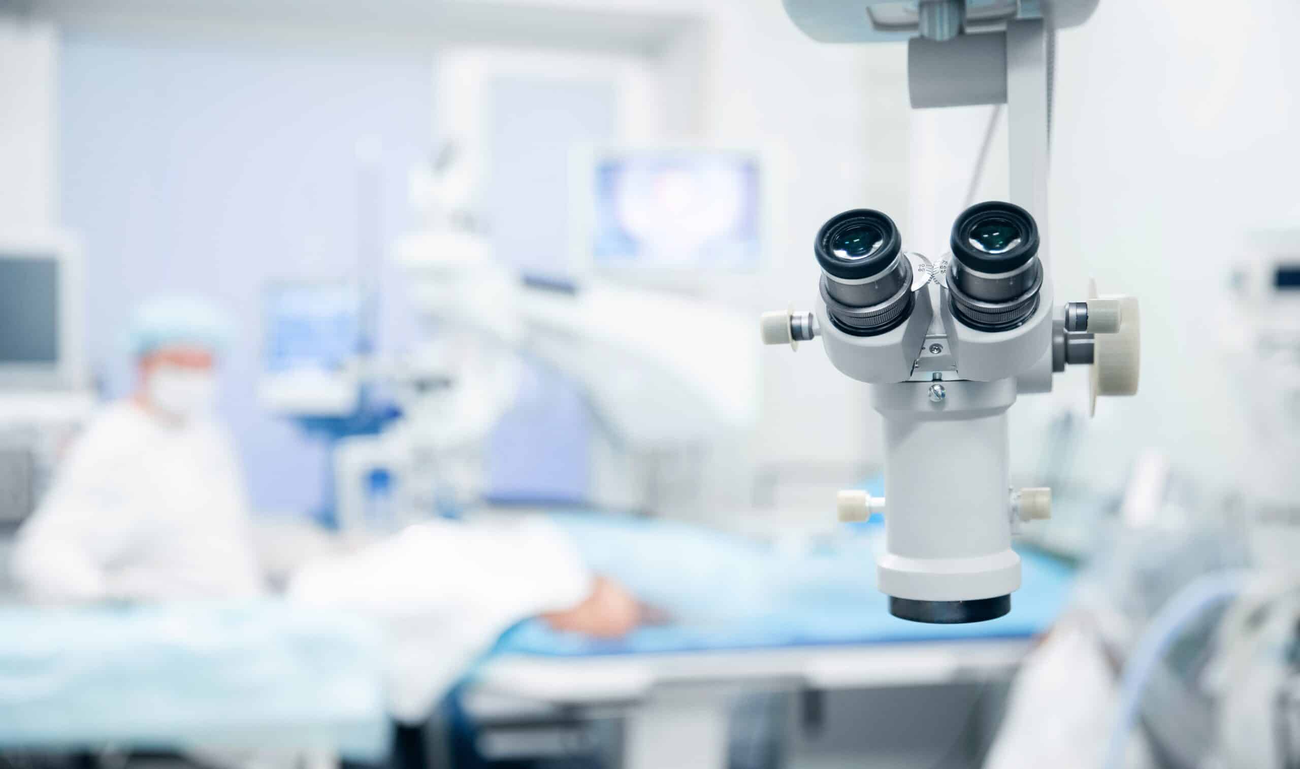 Surgeon looking through a microscope during eye surgery