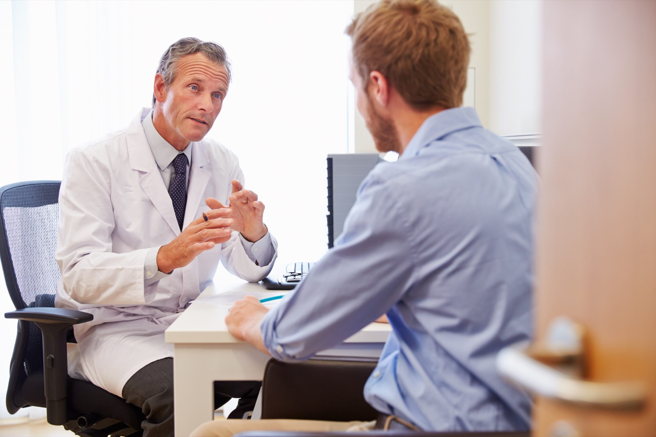 Male patient having a consultation with a doctor in an office