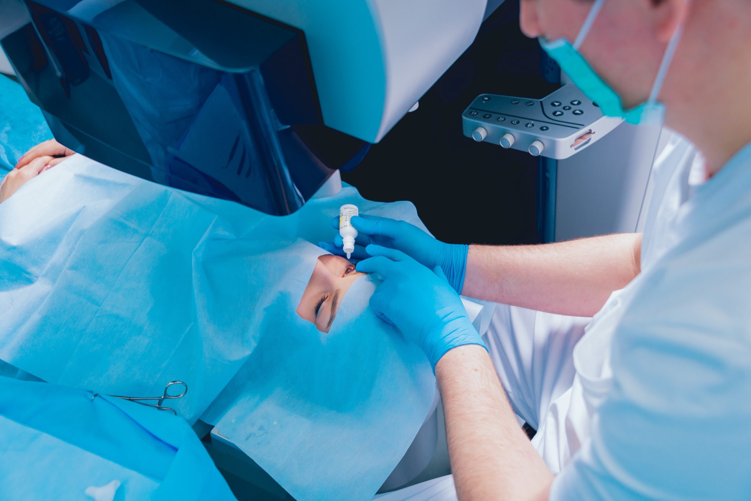 Surgical team performing laser eye surgery in an operating room